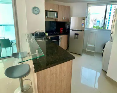 a small kitchen with a counter and a refrigerator at Confort Total con Vista al Mar 11 in Cartagena de Indias