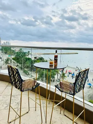 a table and two chairs on a balcony with a beach at Confort Total con Vista al Mar 11 in Cartagena de Indias