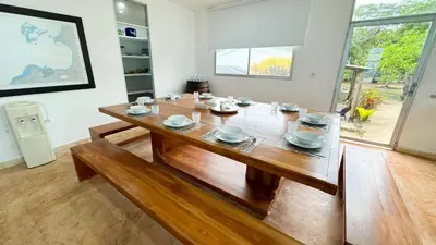 a dining room with a wooden table in a room at Cabaña Costa de Oro in San Antero