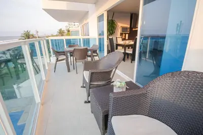 a balcony with chairs and a table on a balcony at Aire puro frente al mar edificio sunshine in Cartagena de Indias