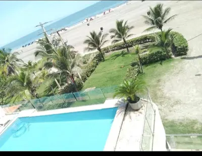 a view of a beach with a swimming pool and the ocean at Aire puro frente al mar edificio sunshine in Cartagena de Indias