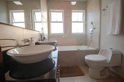 a bathroom with a tub and a toilet and a sink at Aire puro frente al mar edificio sunshine in Cartagena de Indias
