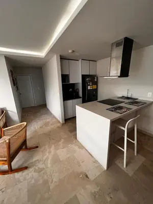 a kitchen with a white island in a room at Aire puro frente al mar edificio sunshine in Cartagena de Indias