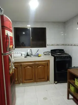 a kitchen with a black stove and a sink at Habitacion privada con servicios incluidos in Barranquilla