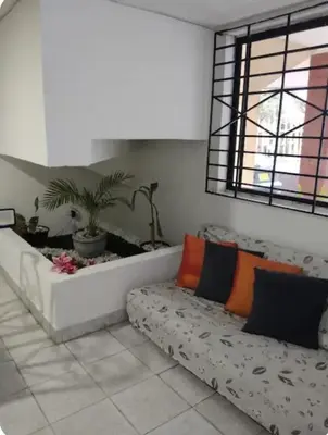 a living room with a couch and a window at Habitacion privada con servicios incluidos in Barranquilla