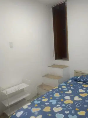 a bedroom with a bed and some stairs at Habitacion privada con servicios incluidos in Barranquilla