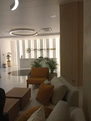 a living room with a couch and a chair at Modern apartment near the airport in Cartagena de Indias
