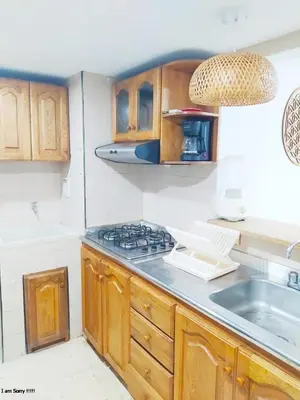 a kitchen with wooden cabinets and a stove top oven at apartamento con vista al mar y centro histórico in Cartagena de Indias
