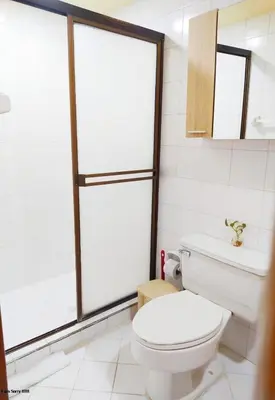 a white bathroom with a toilet and a window at apartamento con vista al mar y centro histórico in Cartagena de Indias