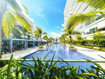 a resort courtyard with palm trees and a swimming pool at Morros Ultra 1 BR - Direct Sea View in Cartagena de Indias