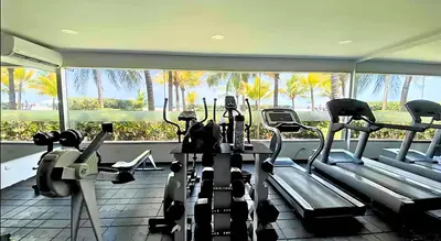 a gym with cardio equipment and a large window at Morros Ultra 1 BR - Direct Sea View in Cartagena de Indias