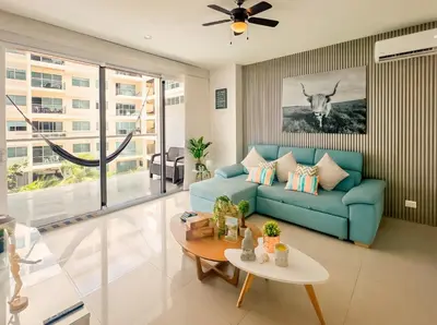 a living room with a blue couch and a table at Morros Ultra 1 BR - Direct Sea View in Cartagena de Indias