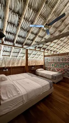 a bedroom with two beds and a ceiling fan at Rincón del Mangle in San Onofre