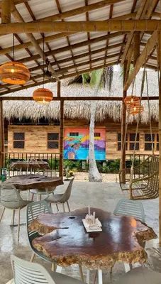 a patio with tables and chairs and a building at Rincón del Mangle in San Onofre