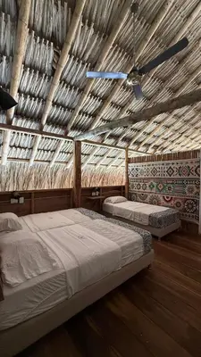 a bedroom with two beds and a ceiling fan at Rincón del Mangle in San Onofre