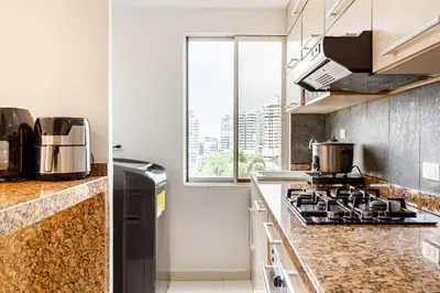 a kitchen with a stove top oven next to a window at Bocagrande Excelente Ubicacion Apto CONFORT con una gran vista al MAR y PLAYAS in Cartagena de Indias