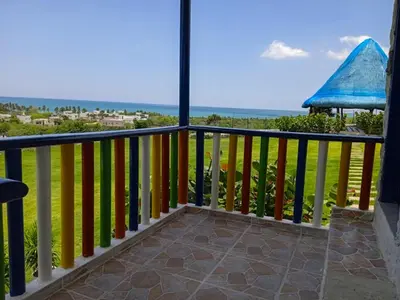 a balcony with a view of the ocean at Liz&Mar Glamping in Tubará