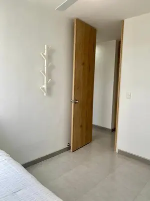 a bedroom with a door and a wall with a cactus sign at U-GO Sunset Frente al Mar in Cartagena de Indias