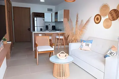 a living room with a couch and a table at Vista impresionante y cama king en Baia Kristal in Los Arrayanes