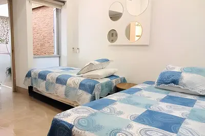 two beds sitting next to each other in a room at Dúplex Frente al Mar cerca C.Amurallada in Cartagena de Indias