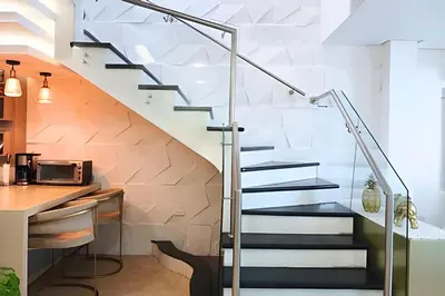 a staircase leading up to a kitchen with a counter at Dúplex Frente al Mar cerca C.Amurallada in Cartagena de Indias