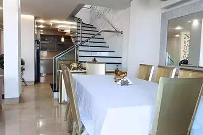 a dining room with a white table and stairs at Dúplex Frente al Mar cerca C.Amurallada in Cartagena de Indias