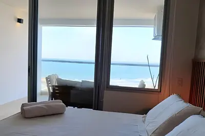 a bedroom with a bed and a large window at Lujoso Apart Studio frente al Mar in Cartagena de Indias