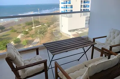 a balcony with a table and chairs and the ocean at Lujoso Apart Studio frente al Mar in Cartagena de Indias
