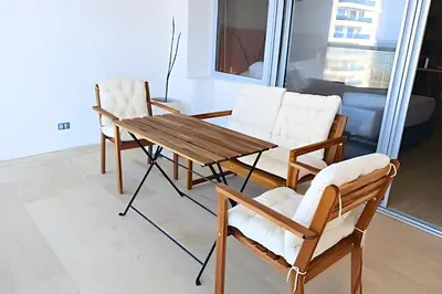 a wooden table and two chairs and a table and chairs at Lujoso Apart Studio frente al Mar in Cartagena de Indias