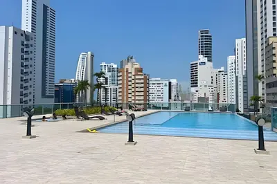 a swimming pool in a city with tall buildings at Chic Apartment Near It All in Cartagena de Indias