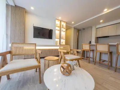 a room with chairs and a table and a tv at Impresionante vista Dominique 2 suites in Cartagena de Indias