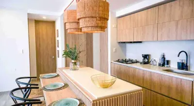 a kitchen with a table with chairs and a counter top at Impresionante vista Dominique 2 suites in Cartagena de Indias