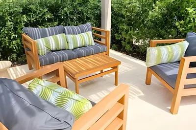 a patio with two chairs and a bench with pillows at Lujo y comodidad Frente al Mar in Cartagena de Indias