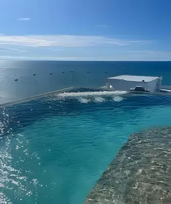 a large pool of water with a building and the ocean at Brand New Apt Pool & City Views in Cartagena de Indias