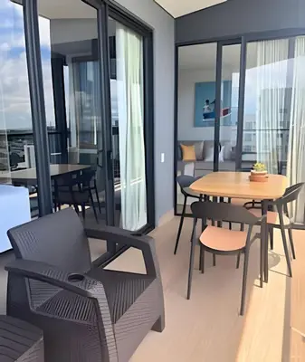 a living room with a table and chairs and a dining room at Brand New Apt Pool & City Views in Cartagena de Indias