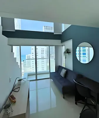 a living room with a couch and a glass table at Bay View Duplex in Bocagrande in Cartagena de Indias