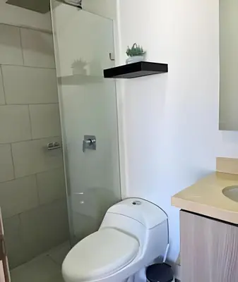 a bathroom with a toilet and a glass shower at Bay View Duplex in Bocagrande in Cartagena de Indias