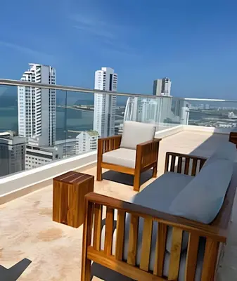 a balcony with a bed and a chair on a roof at Bay View Duplex in Bocagrande in Cartagena de Indias