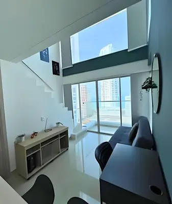 a living room with a couch and a tv at Bay View Duplex in Bocagrande in Cartagena de Indias