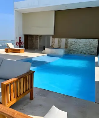 a large pool with blue water in a building at Bay View Duplex in Bocagrande in Cartagena de Indias