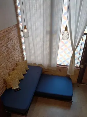 a blue couch sitting in front of a window at Hermoso apartamento con patio privado in Cartagena de Indias