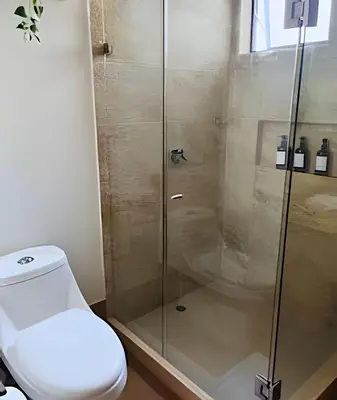 a bathroom with a toilet and a glass shower at Stuning view to Walled city & Beach, King size bed in Cartagena de Indias