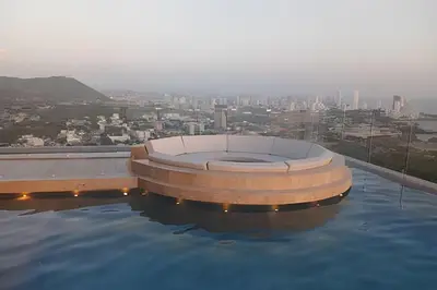 a hot tub sitting on the edge of a swimming pool at Stuning view to Walled city & Beach, King size bed in Cartagena de Indias