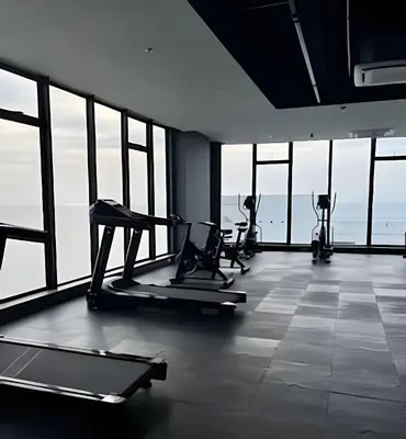 a gym with cardio equipment in a room with windows at Stuning view to Walled city & Beach, King size bed in Cartagena de Indias
