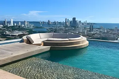 a swimming pool with a couch on top of a city at Oceanfront Gem by Walled City, Spectacular Views in Cartagena de Indias