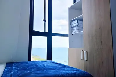 a bedroom with a window and a bed with blue sheets at Oceanfront Gem by Walled City, Spectacular Views in Cartagena de Indias
