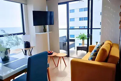 a living room with a yellow couch and a table at Oceanfront Gem by Walled City, Spectacular Views in Cartagena de Indias