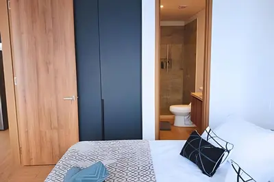 a bedroom with a bed with two pillows on it at Brand New, 3blocks from Walled C, Stunning Views in Cartagena de Indias