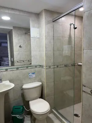 a bathroom with a toilet and a glass shower at Apto a pasos de la playa, ubicación perfecta in Cartagena de Indias