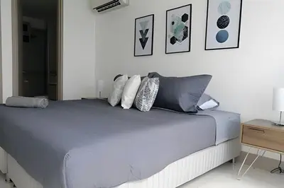 a bedroom with a bed with pillows and a table at Luxury 2B apartment, Amazing View in Cartagena de Indias